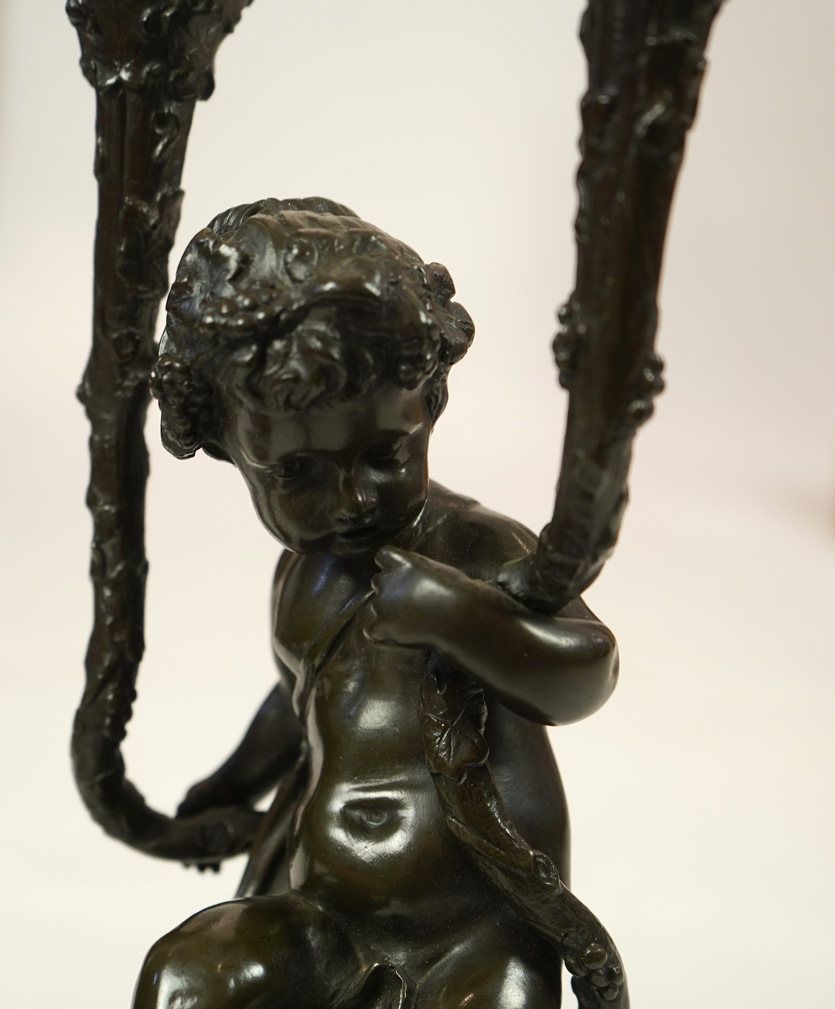 After Clodion. A pair of mid 19th century French bronze two branch figural candelabra